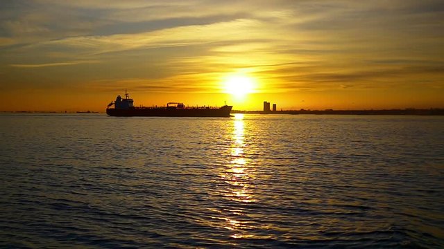 Glittering Sea of Marmara just in time for sundown in Istanbul, Turkey. Tanker ship cruising slow motion on sunset. The atmosphere during sunset, one of the most relaxed you will ever experience in Is