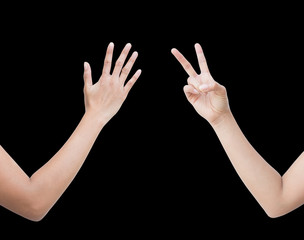 The right back and front side hand of the woman show Rock Paper Scissors sign for find the winners fair in the game. show paper and scissors sign. isolated on black background.