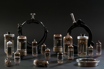 Radio tubes and laboratory equipment on a black background