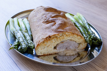 Fillet of pork in pastry crust with green asparagus