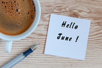Hello June - message at home or office desk. With morning cup of coffee. Summer is Here concept