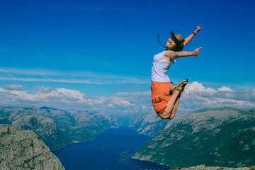 The happy tourist is jumping. Norway. Background.