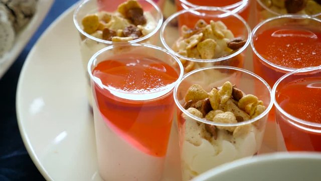 Jelly with cream and nuts in cup