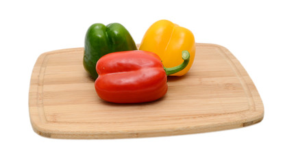 Chopped bell pepers on cutting board wood background