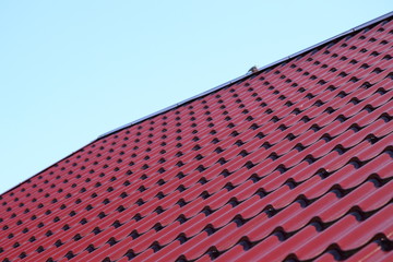 metal shingles on the roof of the house on a Sunny day