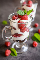 Delicious layered raspberry trifle in a glass jar