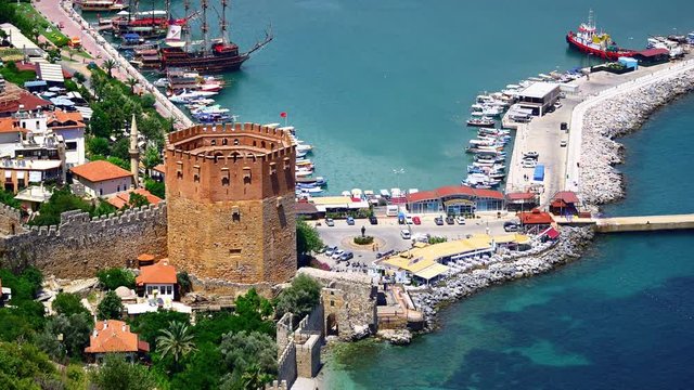 Aerial view of Alanya Red Tower. Kizil Kule is a historical tower in the Turkish city of Alanya. Building is considered to be the symbol of the city. The octagonal red brick tower protects the shipyar