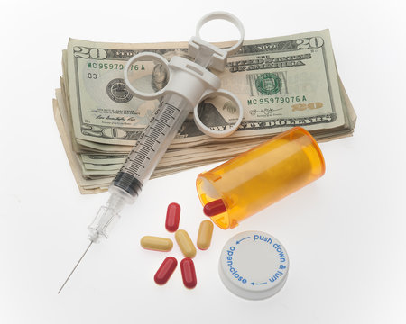 Cost Of Drug Addiction Concept With Needle, Money And Drugs