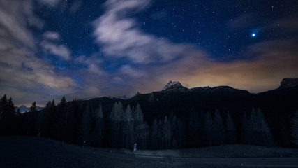 night sky stars and clouds over mountains