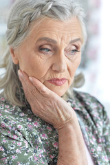 Beautiful sad elderly woman close-up