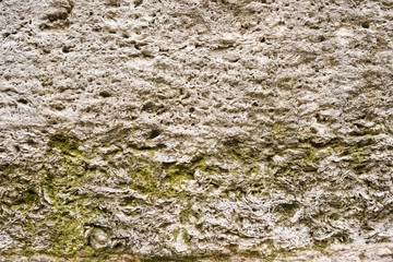 Old unpolished stone wall with grain surface, abstract background. Perfect for background. Selective focus 