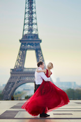 Obraz premium Couple dancing in front of the Eiffel tower in Paris, France