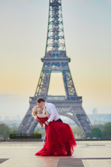 Couple kissing in front of the Eiffel tower in Paris, France