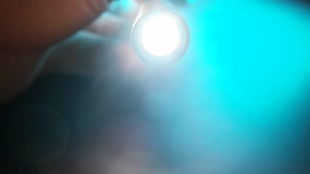 Close up of a mini flashlight in operation
