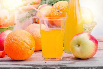 friuts juice in glass and vegetables beside