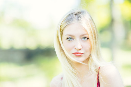 Portrait of young blonde woman with blue eyes.