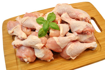 Raw Fresh Chicken Legs on a Wooden Cutting Board 