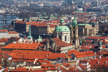 View on the both river banks of Prague Downtown. 
Lesser Town and Old Town of Prague. The tower with clock and cupola of St Nicholas cathedral in the middle.
