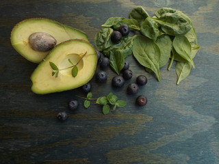 A set of useful foods: spinach, avocados, blueberries and mint