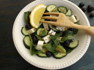 Mixed spinach salad with avocado, blueberry, cucumber and feta cheese. Fitness, diet concept