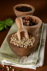 White pepper in wooden bowl - closeup