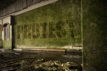 text protest on the dirty old wall in an abandoned ruined house