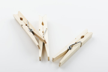 Three wooden clothespin on white background. Isolated. Horizontal shoot.