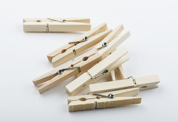 Wooden clothespin stacked on white background. Isolated.