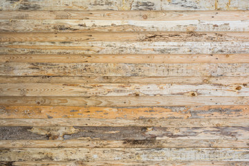 The texture of the wall made of wooden planks located horizontally, the surface of the wood is poorly treated, many wood fibers and cracks