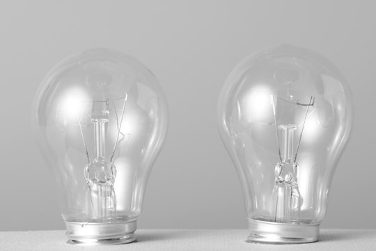 Three incandescent bulbs on grey background