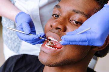 African male patient getting dental treatment in dental clinic