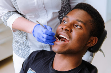 African male patient getting dental treatment in dental clinic
