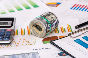 roll dollar on business graph with calculator.