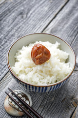 Traditional Japanese Koshihikari Rice with Umeboshi as close-up in a bowl