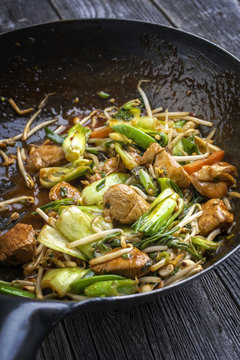 Traditional stir fried Chicken Gung Bao with Vegetable as close-up in Wok