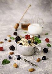 Healthy breakfast with oat flakes, raspberry berries, blueberries, selective focus
