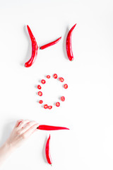 red food with chili pepper hot text on white background top view