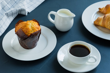 Breakfast. Coffee with milk muffin and croissants.