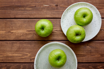 summer food with green apples on wooden background top view