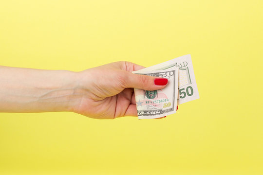 American dollars in the woman's hand, yellow background