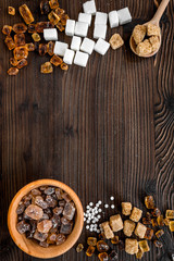 lumps and sanding sugar for sweets on wooden kitchen table background top view mock up