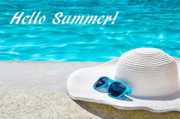 Hello Summer background with hat and sunglasses near the pool