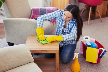 Concentrated female doing her best to clean table