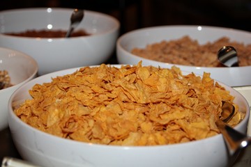 A white bowl filled with cereal, sideview A ceramic bowl of cereal ready for breakfast to start everyone’s day.