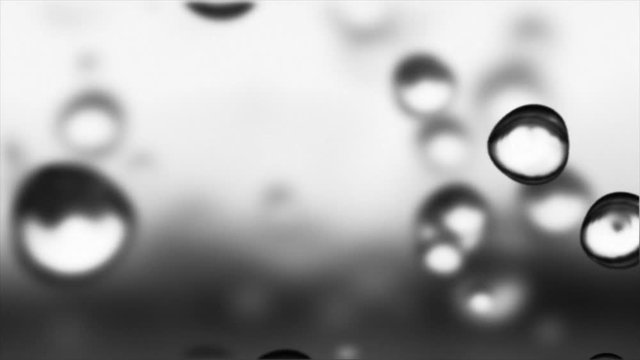 Raindrop series - macro of raindrops falling. Loopable background. 