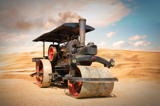 Old steam roller on riding on desert after apocalypse. Steam engine from 19th century on retro style picture.