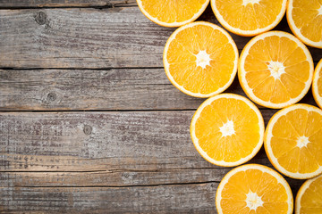 Close up shot of half cut oranges on an old wooden background