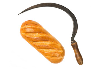 Vintage reaper hook sickle and bread isolated on white background