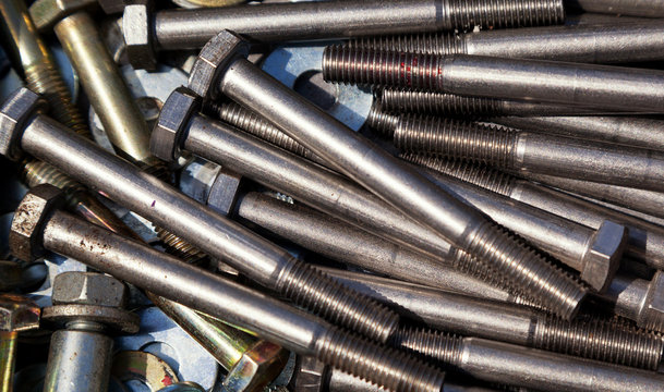 Stack of long bolts piled up to create a background which can be used for text.