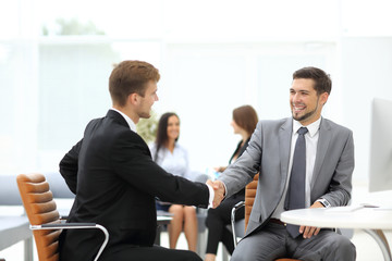 Business meeting at the table with handshake